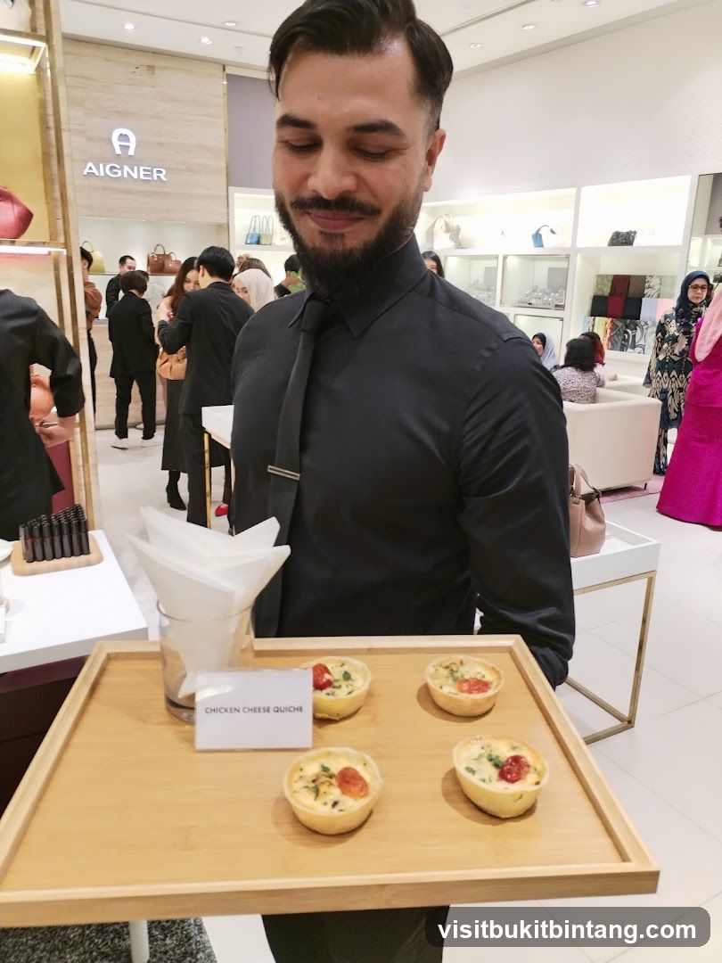 Staff offering quiches at a store event
