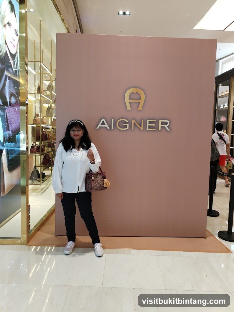 Woman Poses in Front of Aigner Logo