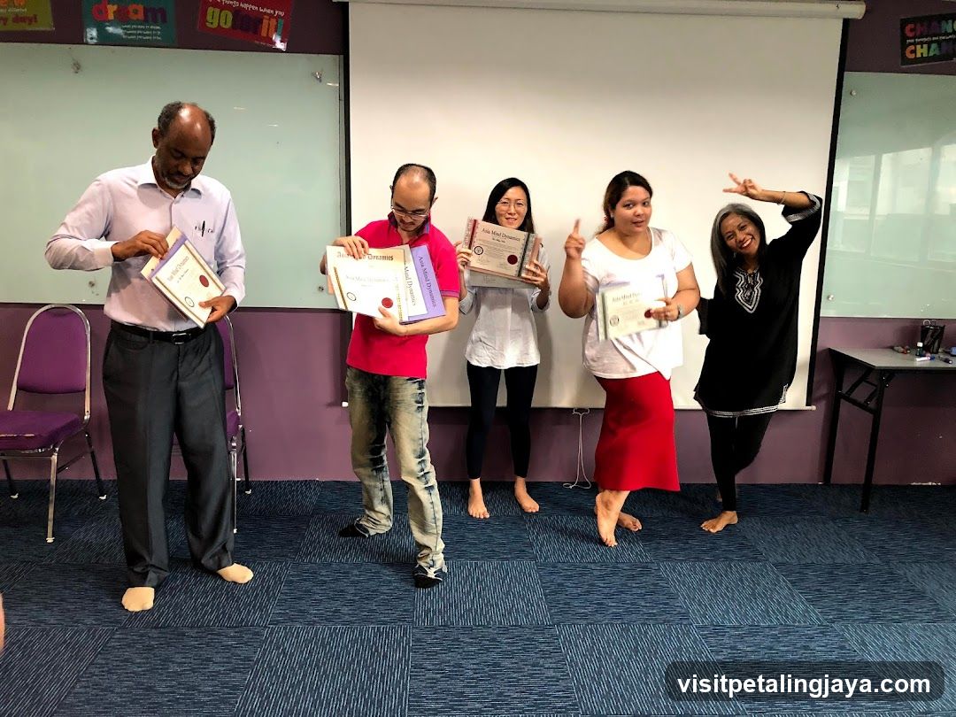 Group holding certificates in classroom