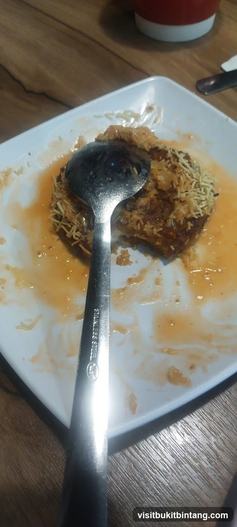 Partially Eaten Dish with Spoon