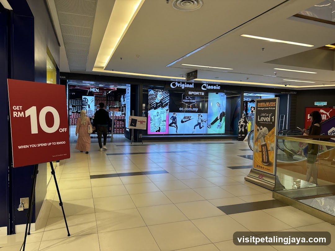 Shopping Mall Interior with Storefronts and Promotional Displays