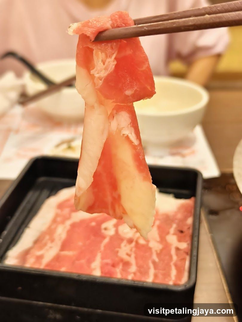 Sliced Meat Being Held with Chopsticks