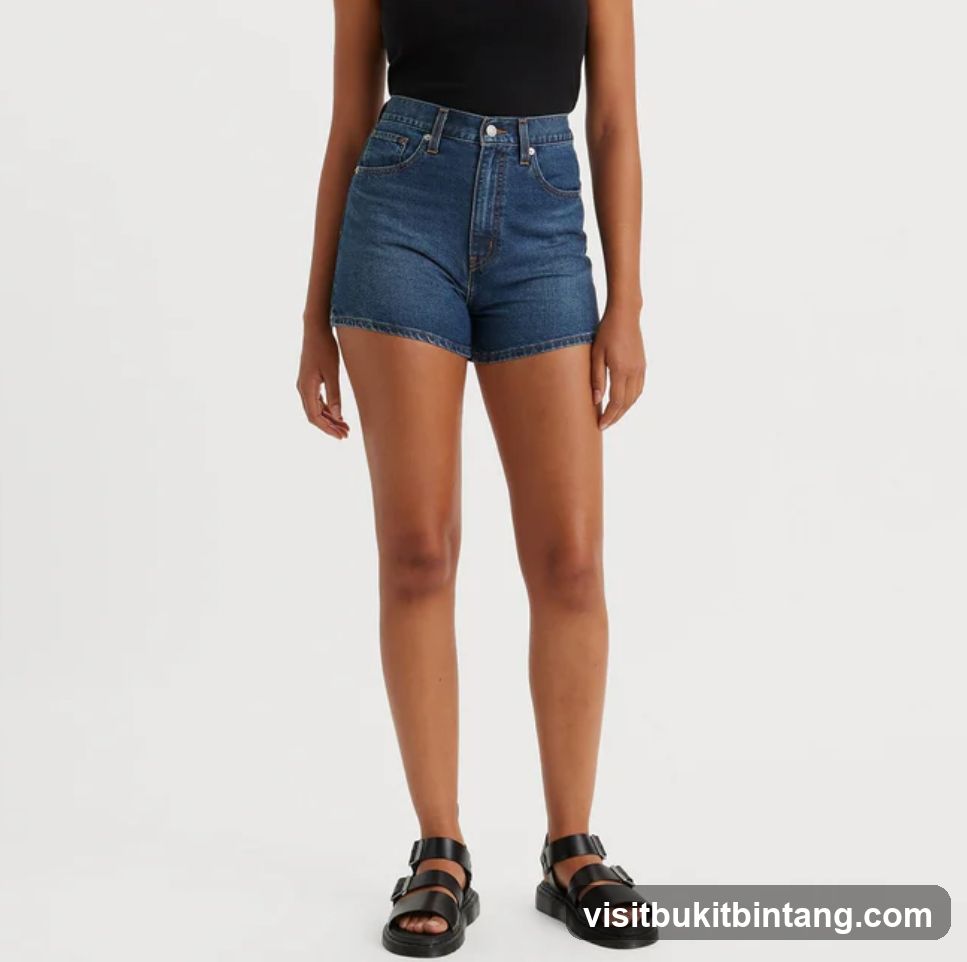Woman wearing denim shorts and black tank top