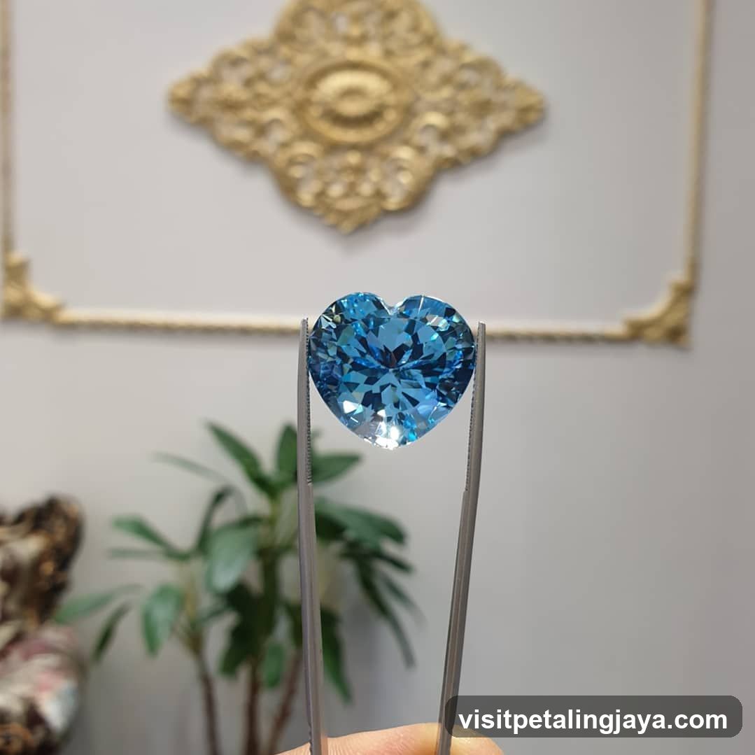 Heart-Shaped Blue Gemstone on Tweezers