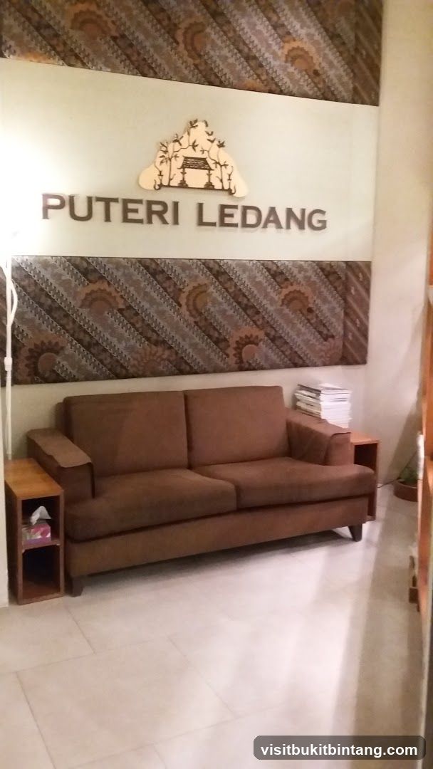 Waiting area with couch and signage