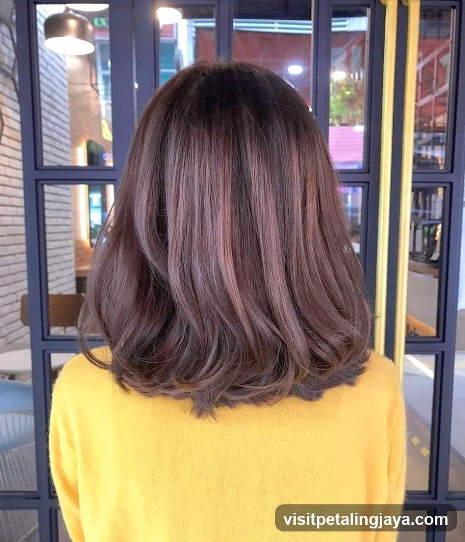 Back view of person with shoulder-length hair in yellow sweater