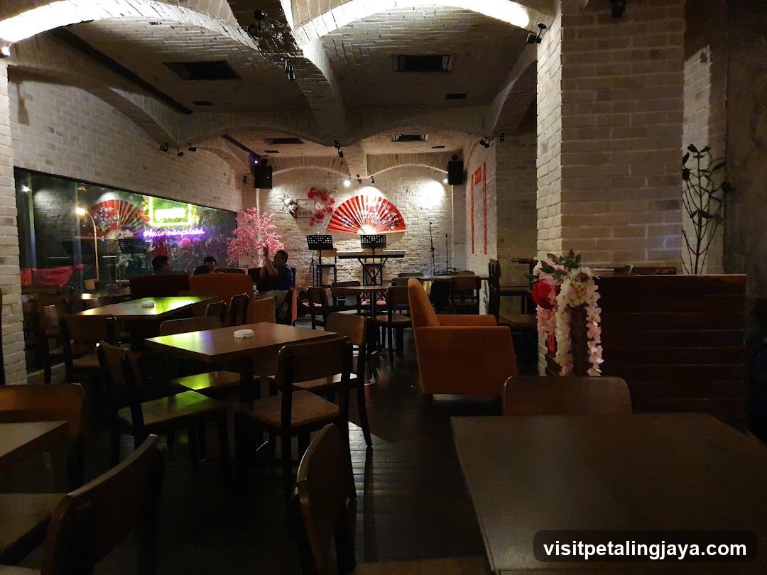 Interior of a dimly lit restaurant or bar with brick walls and decorative fans