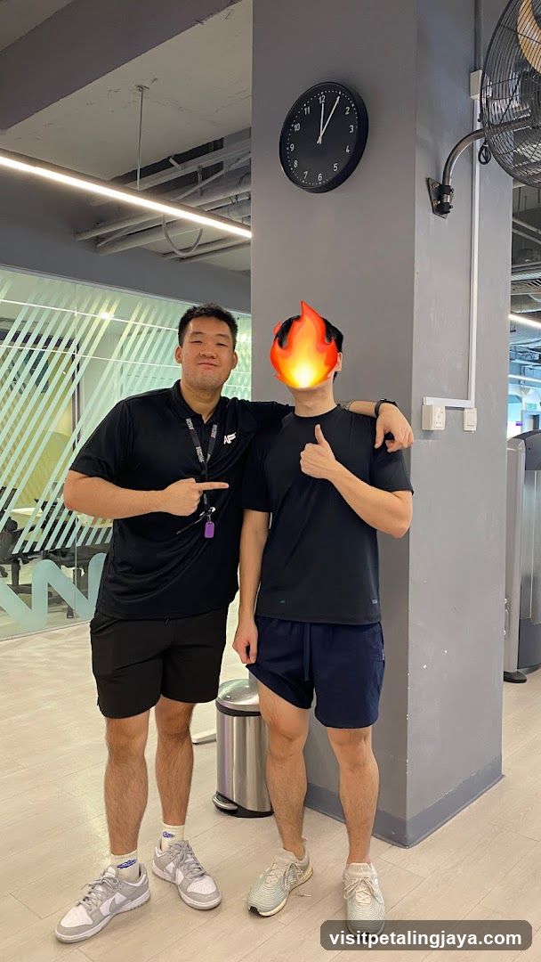 Two men in gym attire posing indoors