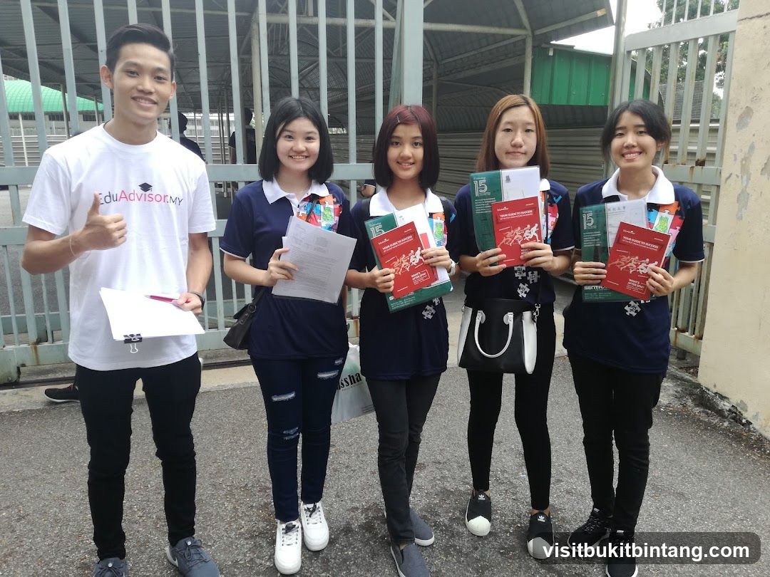 Group of students holding educational materials