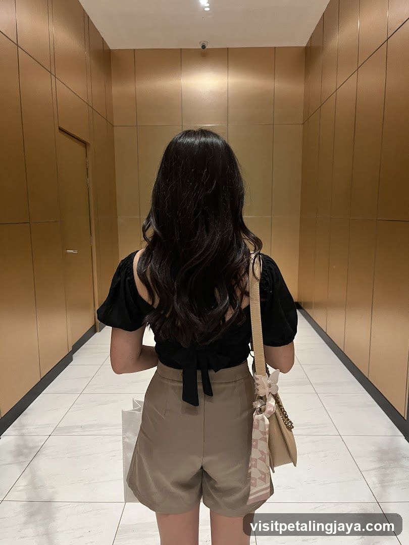 Woman in hallway with bag and shorts