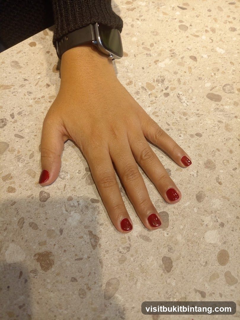 Hand with red nail polish