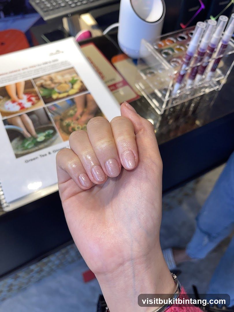 Hand with manicured nails and spa menu