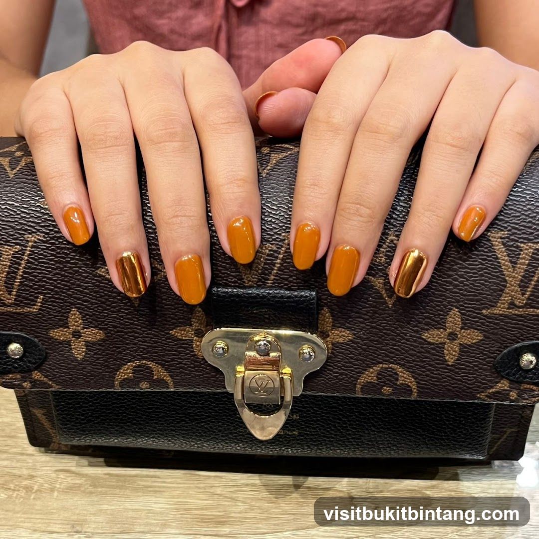 Woman's Hands with Orange and Gold Nails