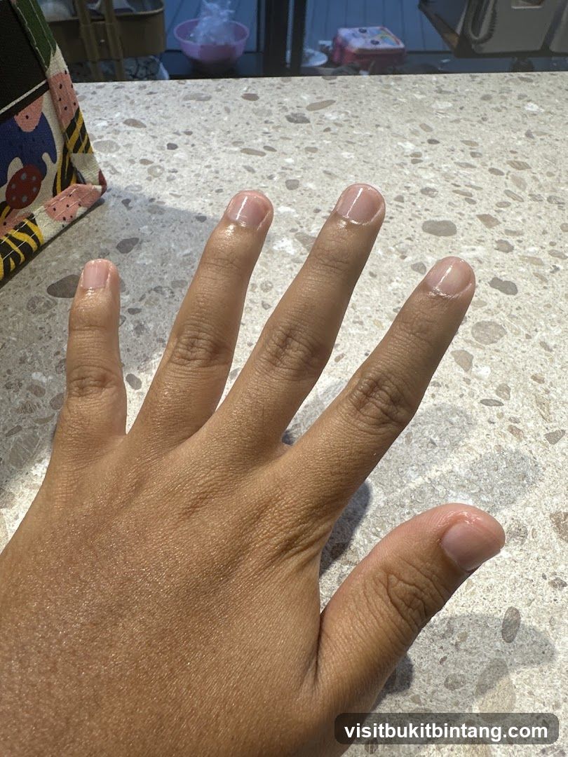 Hand with clear nail polish
