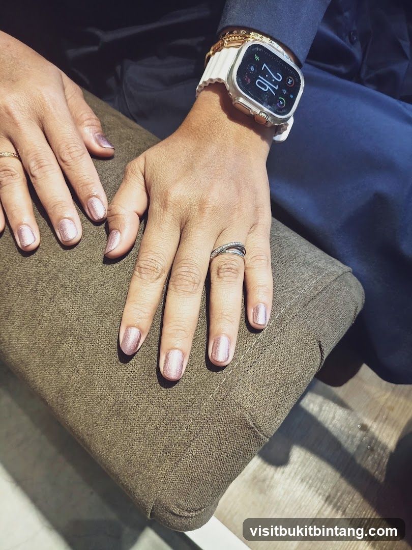Close-up of hands with manicured nails and a smartwatch