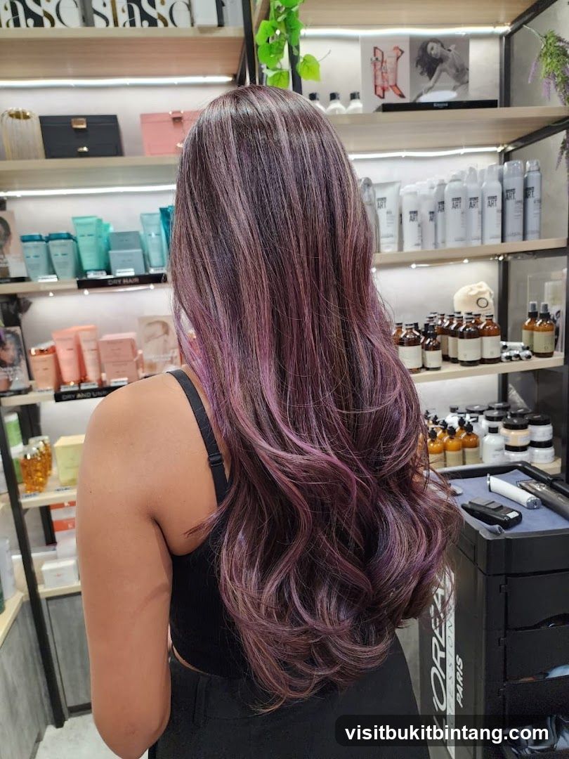 Woman with purple-highlighted hair in a salon