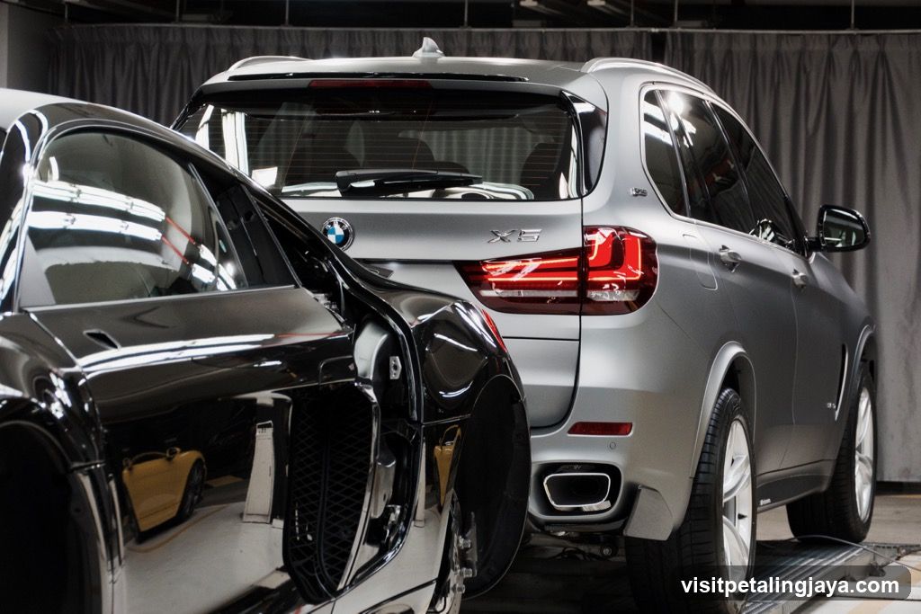 BMW X5 and Bentley in a showroom or garage setting