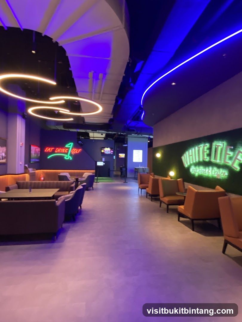 Indoor entertainment venue with seating and neon signs