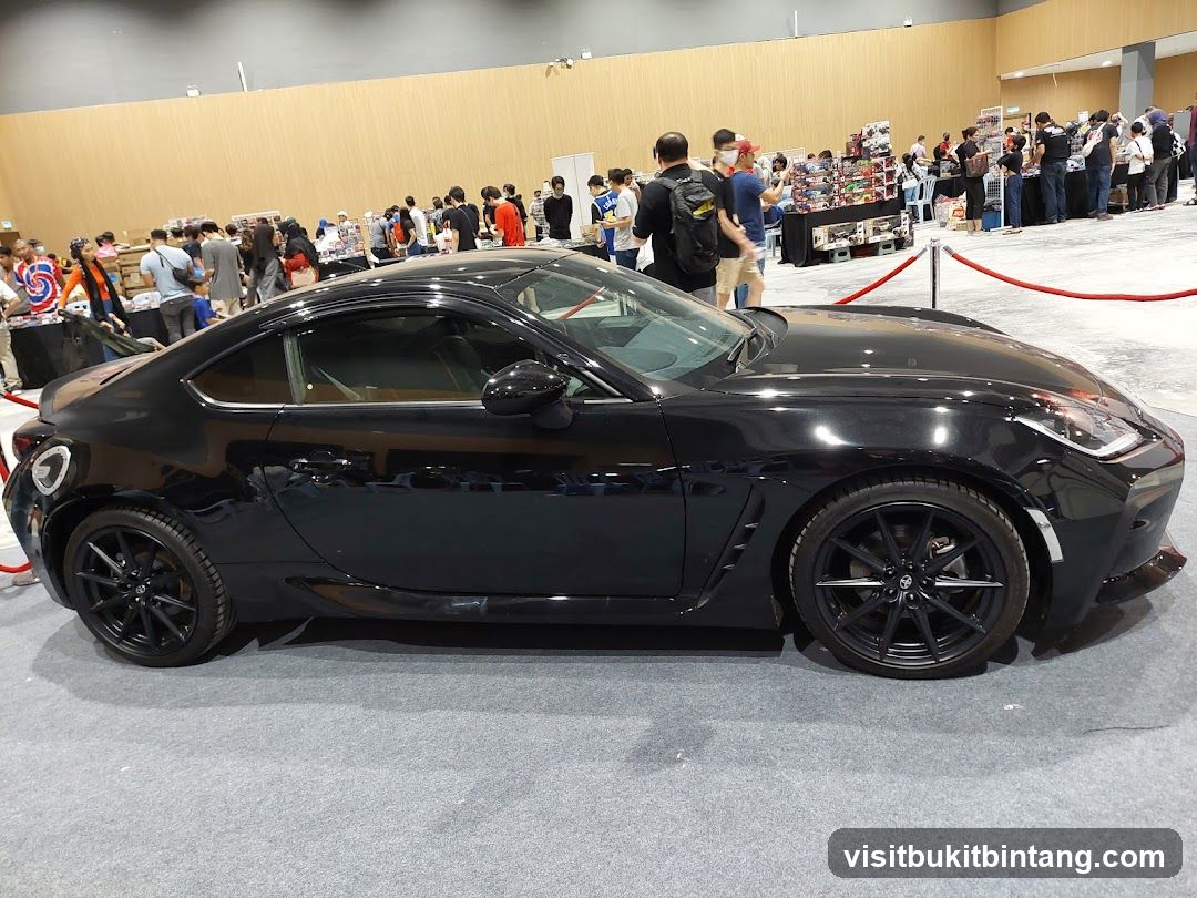 Black sports car on display at an event