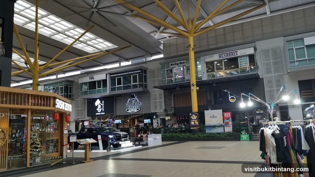 Outdoor shopping mall with various storefronts and displays