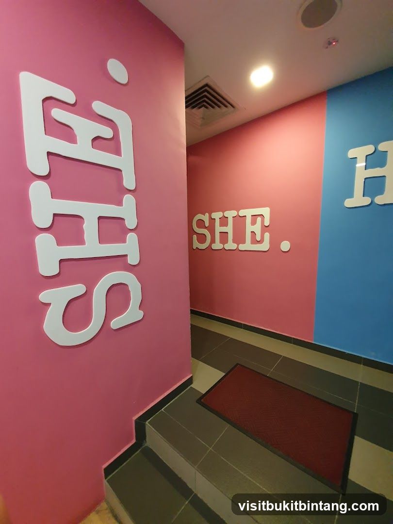 Hallway with "SHE" and "HE" signage