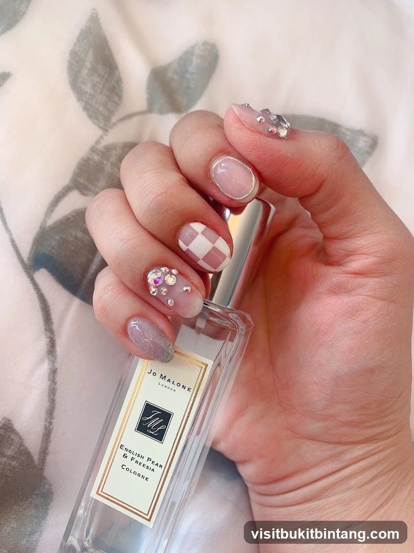 Hand holding Jo Malone perfume bottle