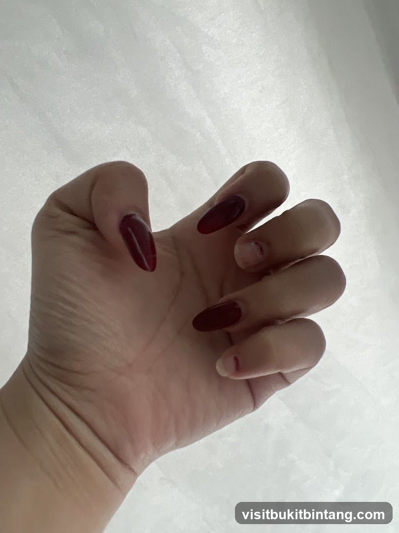 Hand with dark red nails
