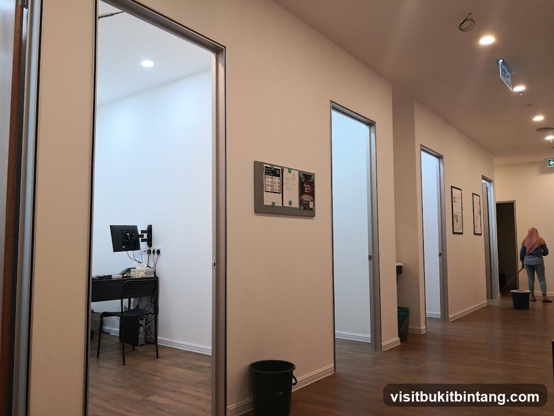 Office hallway with workstations and cleaning staff