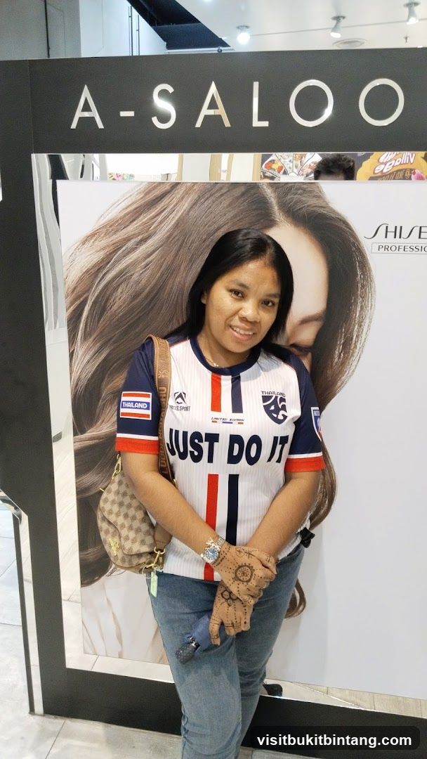 Woman in front of salon advertisement