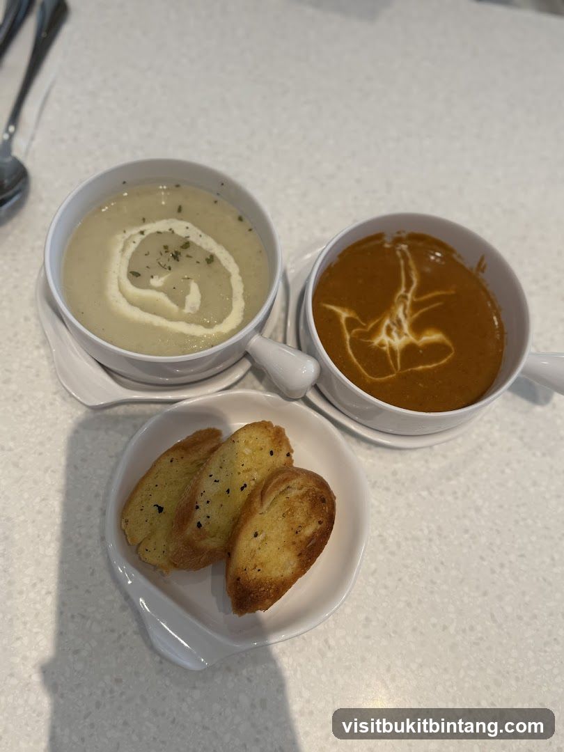 Two bowls of soup with garlic bread