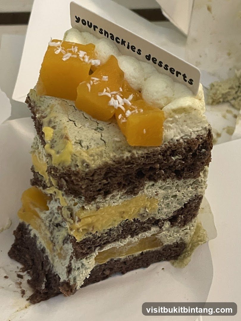 Slice of layered cake with mango and coconut