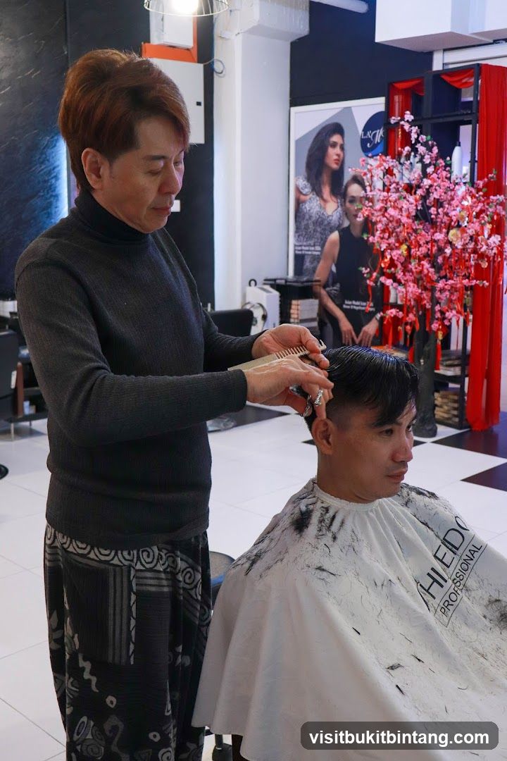 Hairdresser cutting client's hair