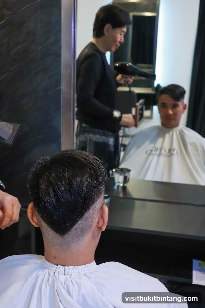 Hairdresser drying client's hair