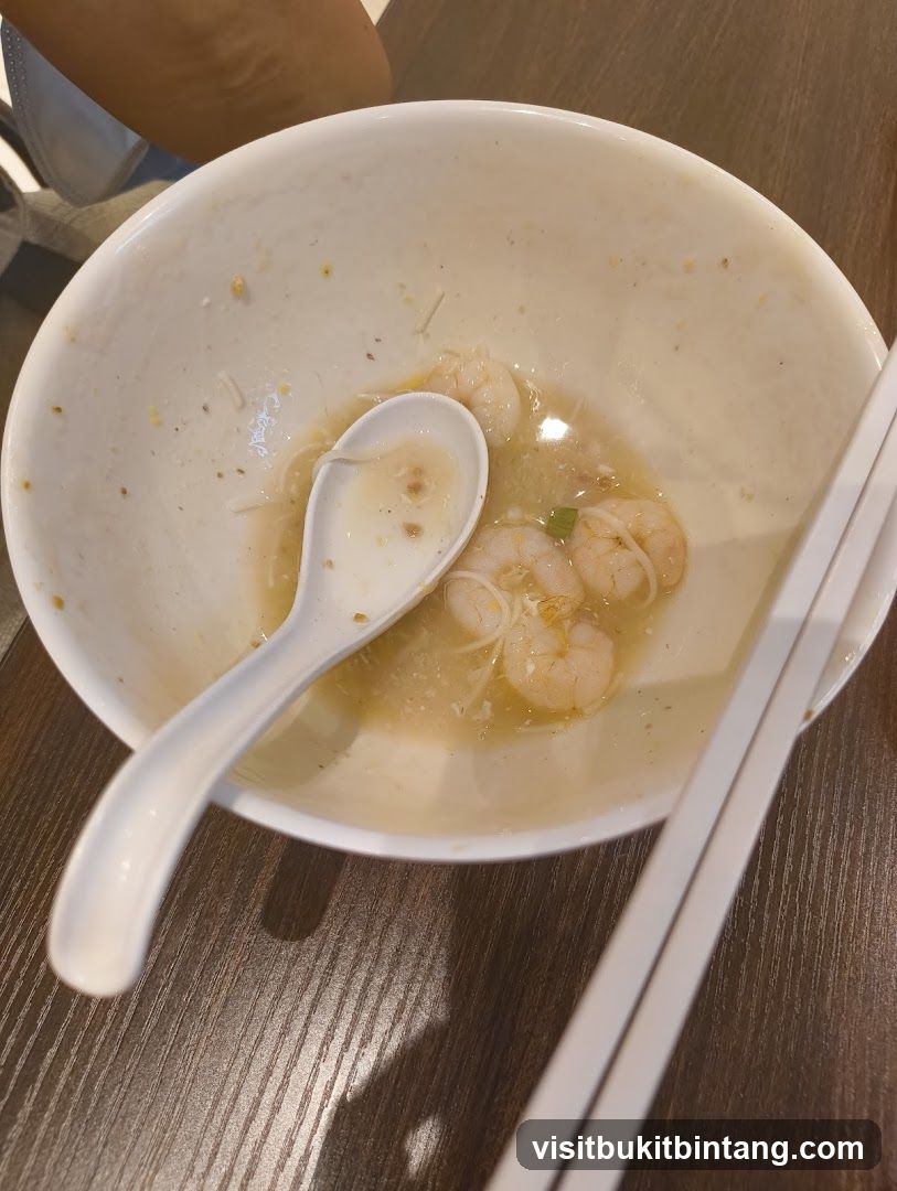 Partially Eaten Bowl of Noodles with Shrimp