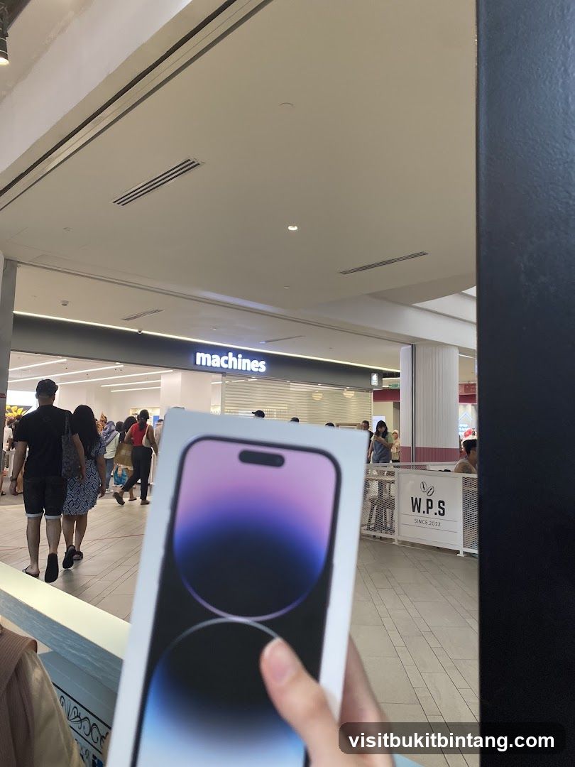 Person holding a new iPhone box in front of a store