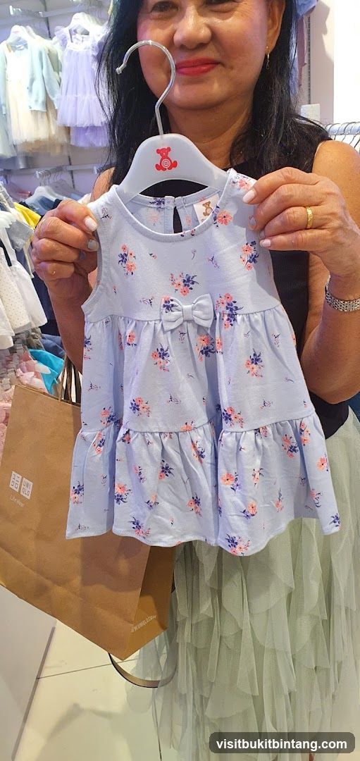 Woman holding a baby dress