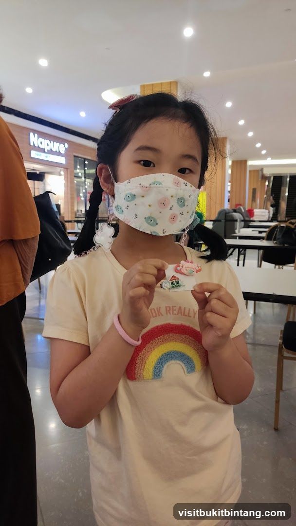 Girl with mask and rainbow shirt