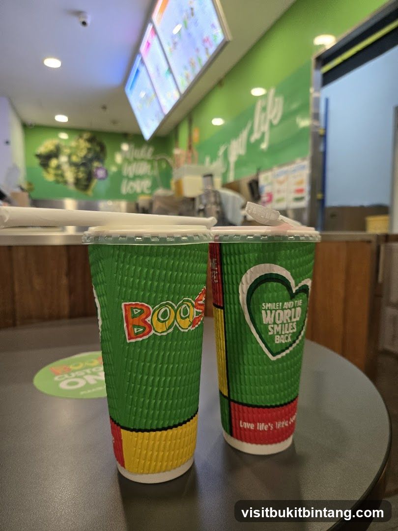 Two green cups with straws on a table