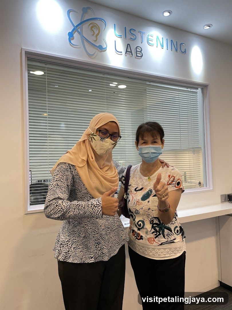 Two women posing in front of Listening Lab
