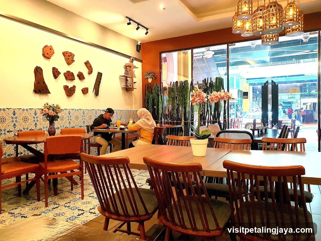 Interior of a cozy café with wooden furniture and decorative wall art