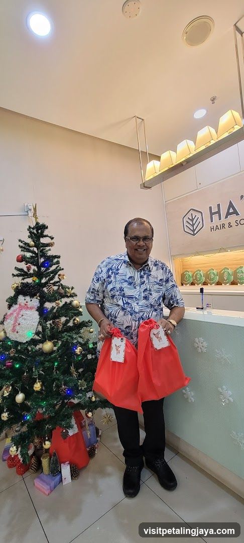 Man with Gift Bags Near Christmas Tree