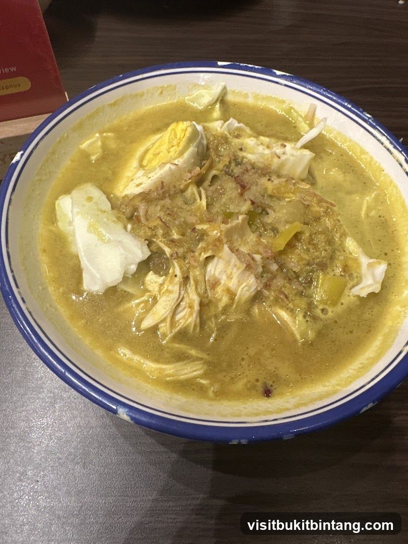 Bowl of Soup with Egg and Shredded Chicken