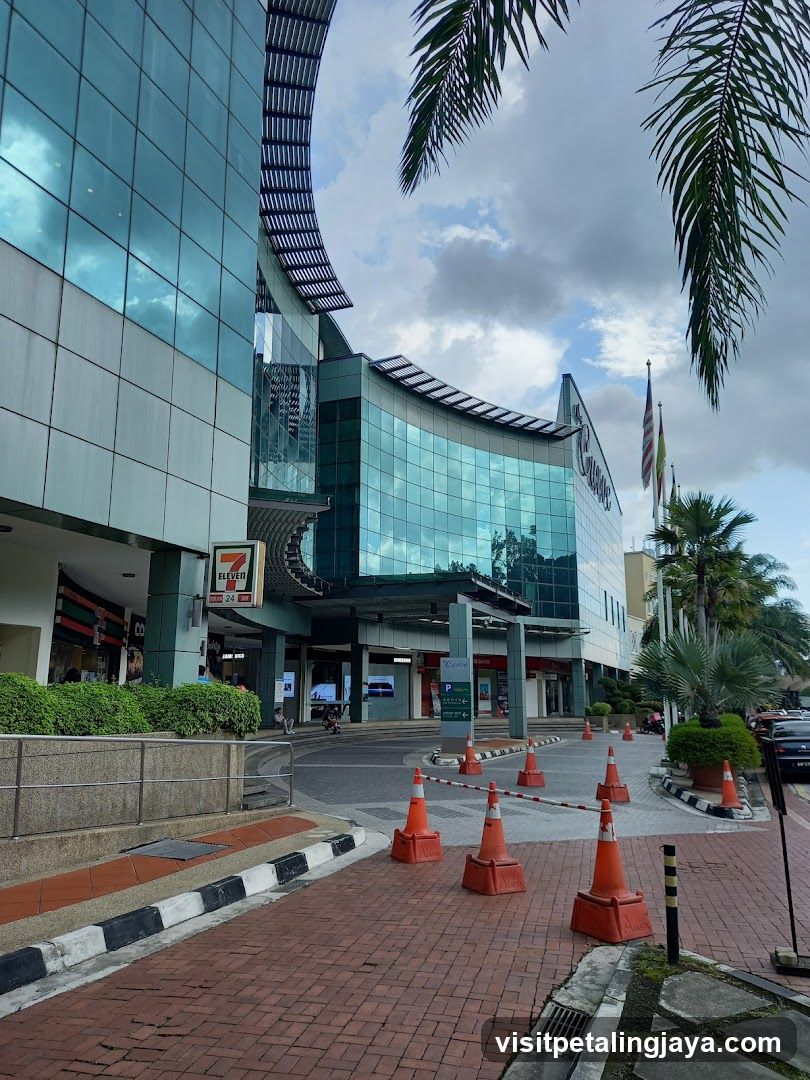 Shopping Center Exterior with Storefronts and Traffic Cones