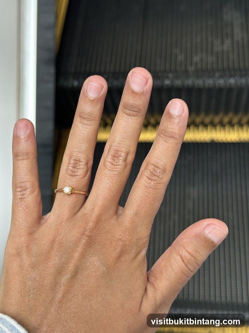 Hand with Ring on Escalator