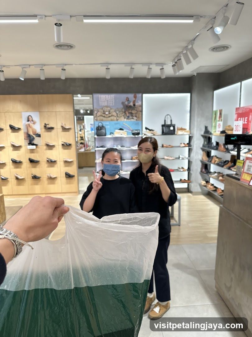 Shoe Store Interior with Staff and Shopping Bag
