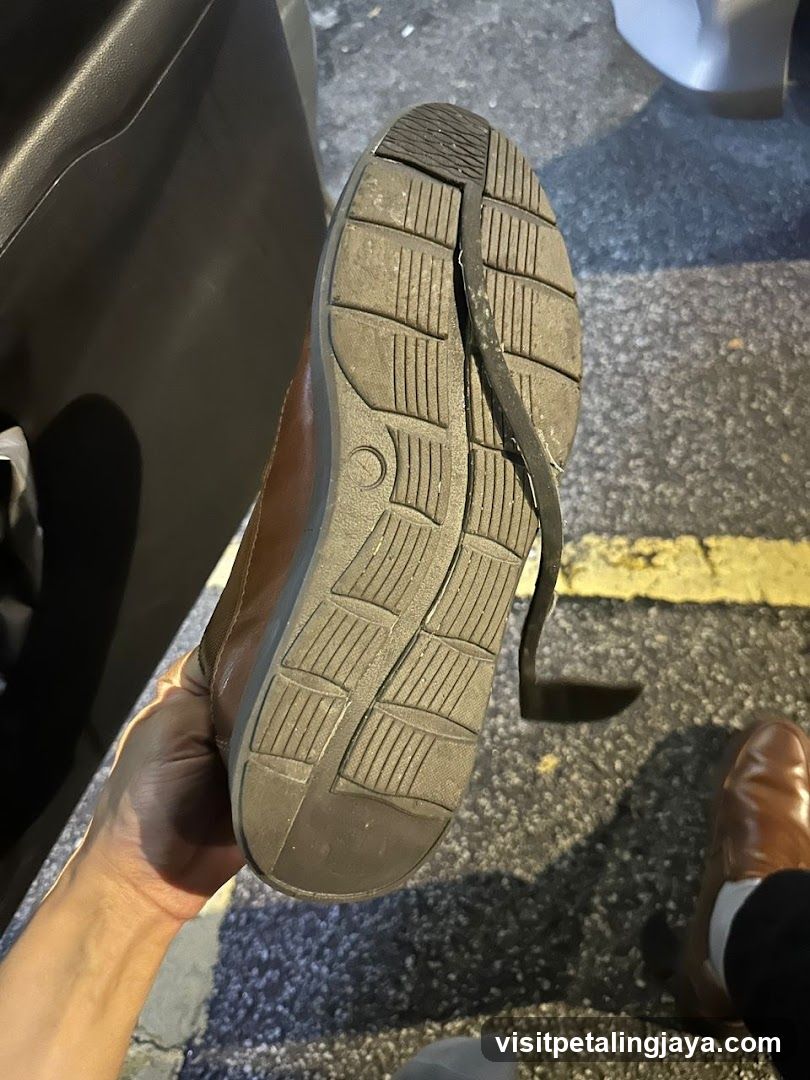 Sole of a worn shoe held in hand