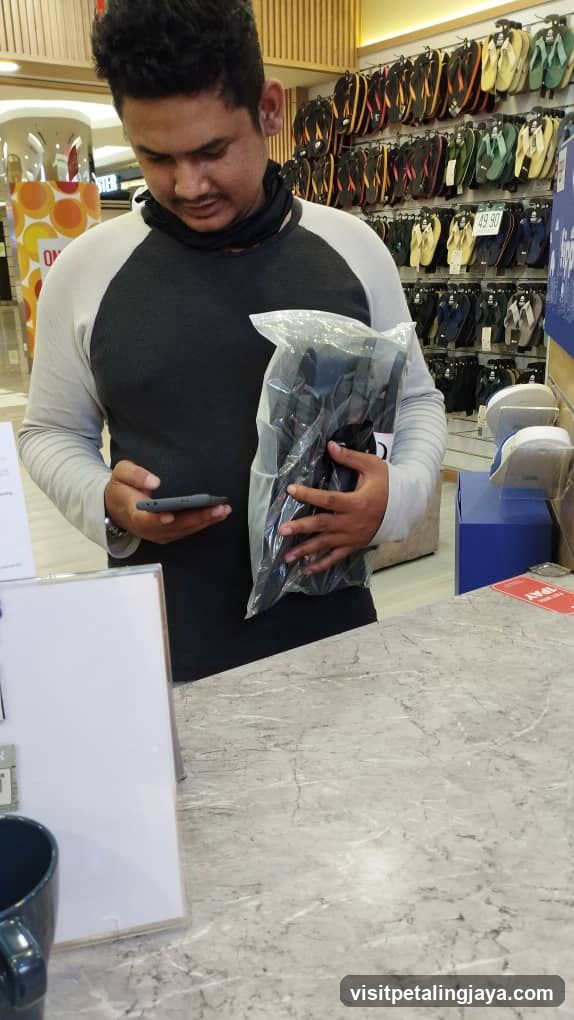Customer in Store Holding Product