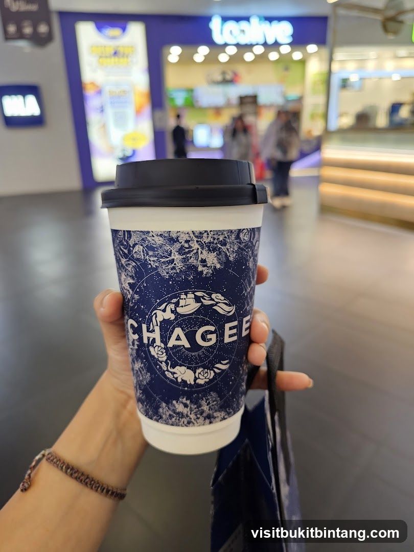 Person holding a cup with a logo