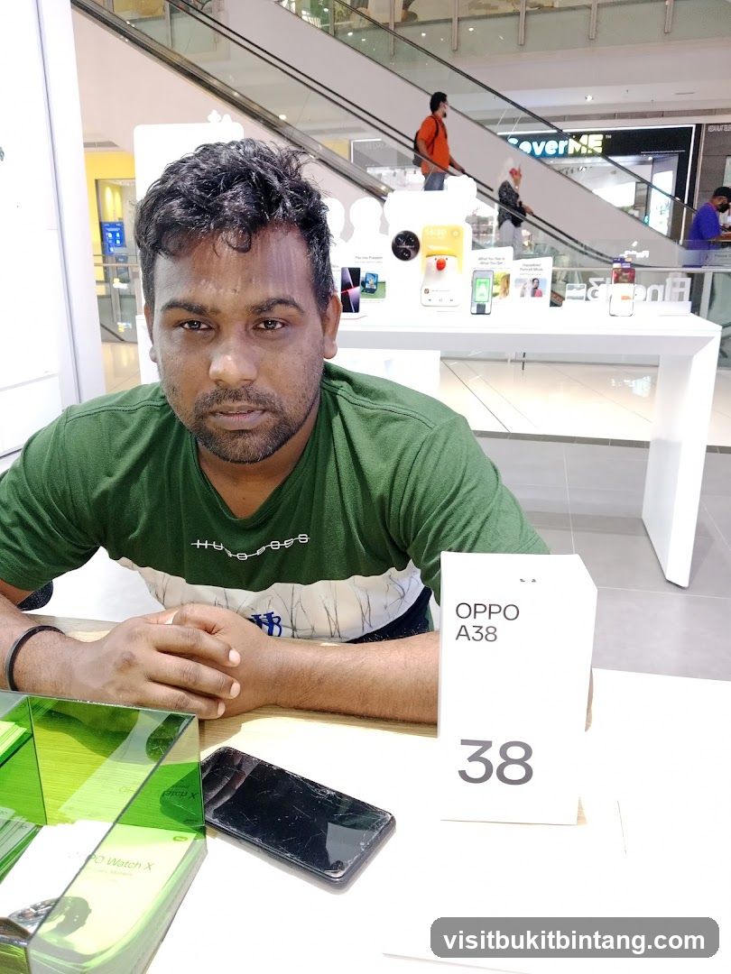 Man sitting at a table with a phone and product box