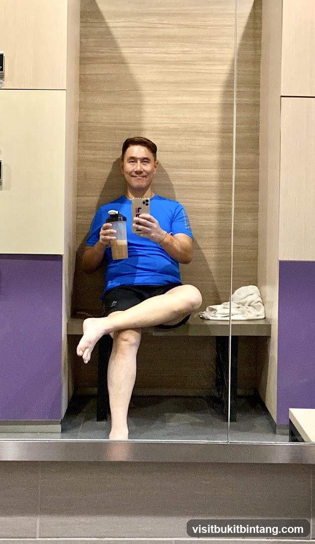 Man in locker room with protein shake